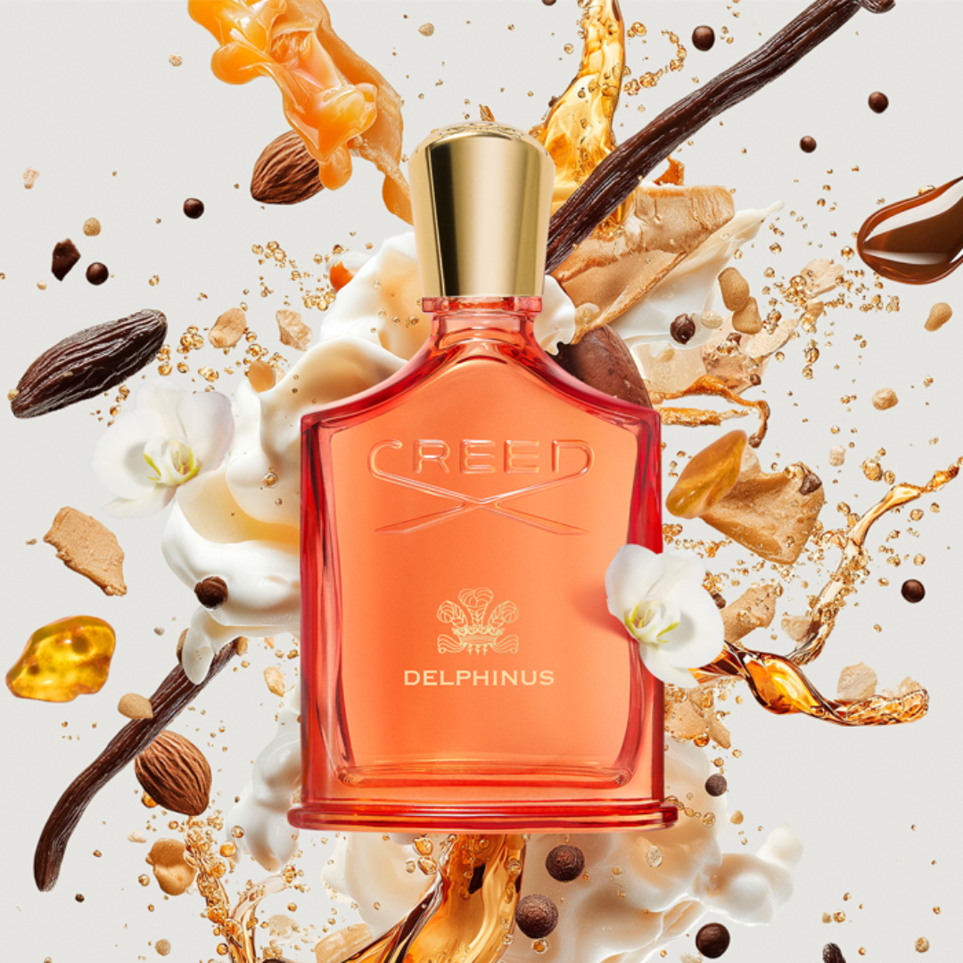 Dynamic artistic composition of Creed Delphinus Eau de Parfum 100 ml surrounded by golden spice bursts, symbolizing its rich oriental-amber notes of vanilla, patchouli, and tonka bean.