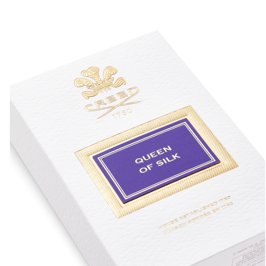 Elegant white and gold Creed Queen of Silk EDP 75 ml box featuring the signature Creed emblem, reflecting luxury craftsmanship and royal presentation.