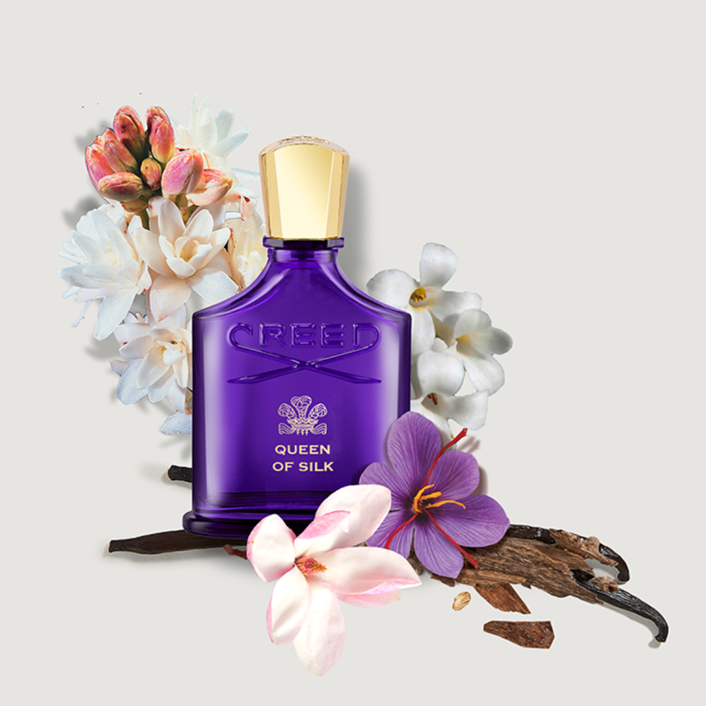 Artistic composition of Creed Queen of Silk EDP 75 ml bottle with floral accents of magnolia and tuberose, capturing the fragrance’s luminous sophistication and sensual amber-floral allure.