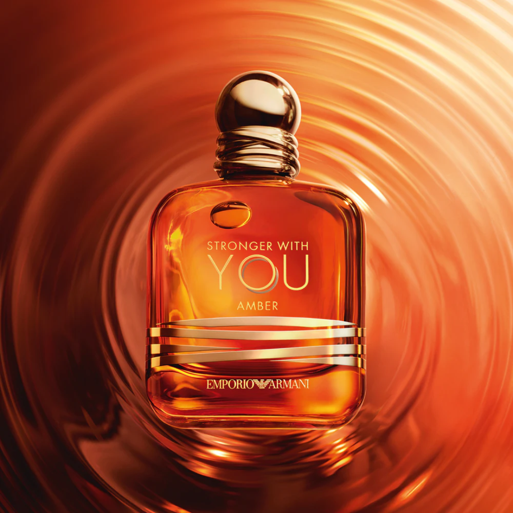 Artistic photo of Emporio Armani Stronger With You Amber EDP 100 ml surrounded by glowing amber tones. Captured for Fragrance Emporium to express the fragrance’s luminous balance of freshness and sensuality — an elegant, warm scent with amber and vanilla depth.