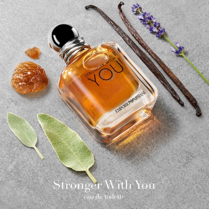Artistic flat lay of Giorgio Armani Stronger With You Eau de Toilette 110ml bottle with aromatic elements like lavender and sage. Captured for Fragrance Emporium to express the warm, spicy, and romantic fougère fragrance that defines masculine sophistication and confidence.