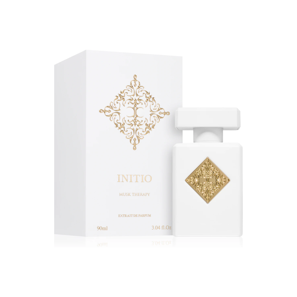 Initio Musk Therapy Extrait 90 ml bottle and box in white and gold design. A refined unisex fragrance with notes of black currant, bergamot, magnolia, and white musk. Sold by Fragrance Emporium.
