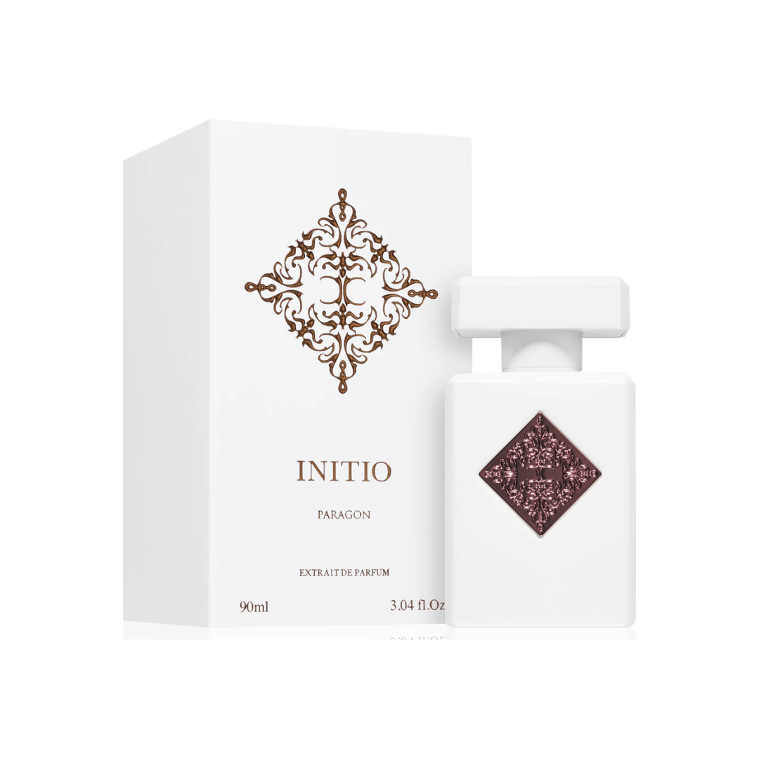 Initio Paragon Extrait 90 ml bottle and box in elegant white and burgundy design. A luxurious unisex fragrance with bergamot, lavender, plum, and oud. Shop exclusive scents at Fragrance Emporium.
