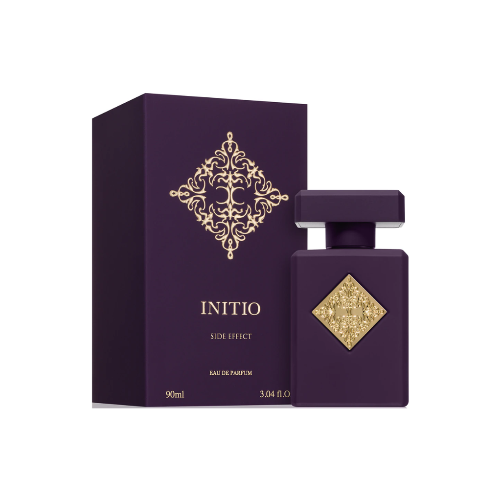 Initio Side Effect EDP 90 ml bottle and box set in rich purple with gold detailing. A sensual unisex Eau de Parfum combining rum, tobacco, cinnamon, and vanilla. Sold by Fragrance Emporium.
