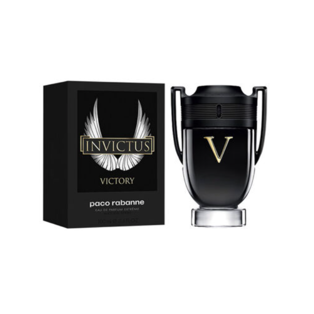 Luxurious presentation of Invictus Victory by Paco Rabanne Eau de Parfum 100 ml with its matching black and gold packaging. The image emphasizes the perfume’s premium craftsmanship and modern elegance, blending spicy freshness and warm vanilla amber accords for a victorious, long-lasting masculine scent.