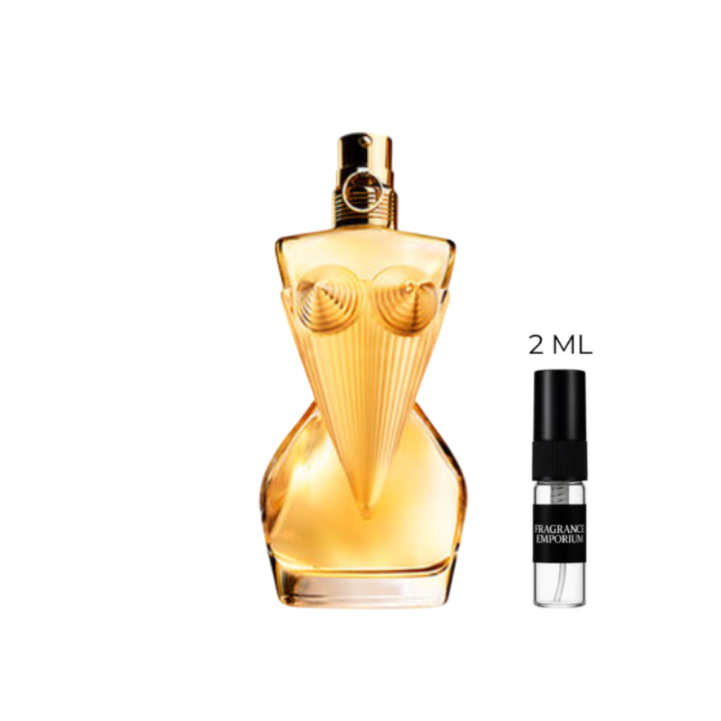 Jean Paul Gaultier Divine Eau de Parfum bottle beside a 2 ml sample vial on a white background, showing its gold and pink design. A modern women’s fragrance with lily, bergamot and meringue notes — luxurious and feminine, available in 2 ml premium decants from Fragrance Emporium.