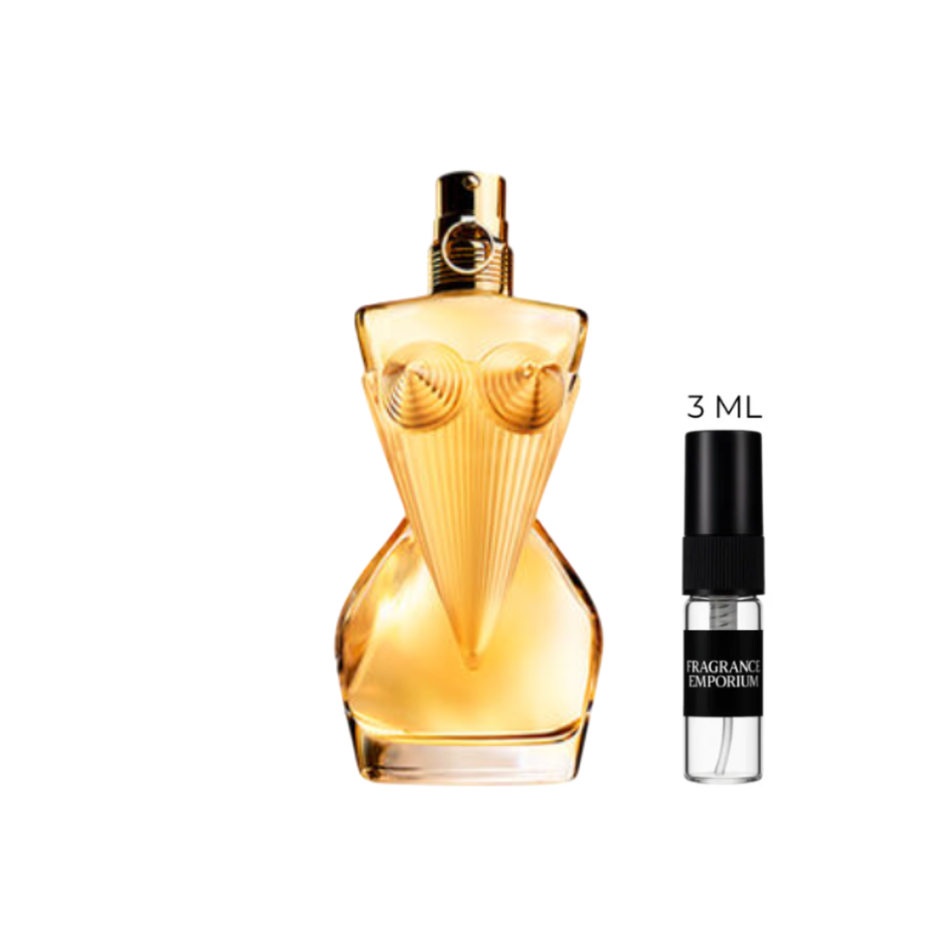 Studio photo of Jean Paul Gaultier Divine Eau de Parfum bottle paired with a 3 ml sample vial. This floral-amber scent combines ylang-ylang, jasmine, and meringue for a sweet yet sophisticated touch — available as 3 ml decants from Fragrance Emporium.