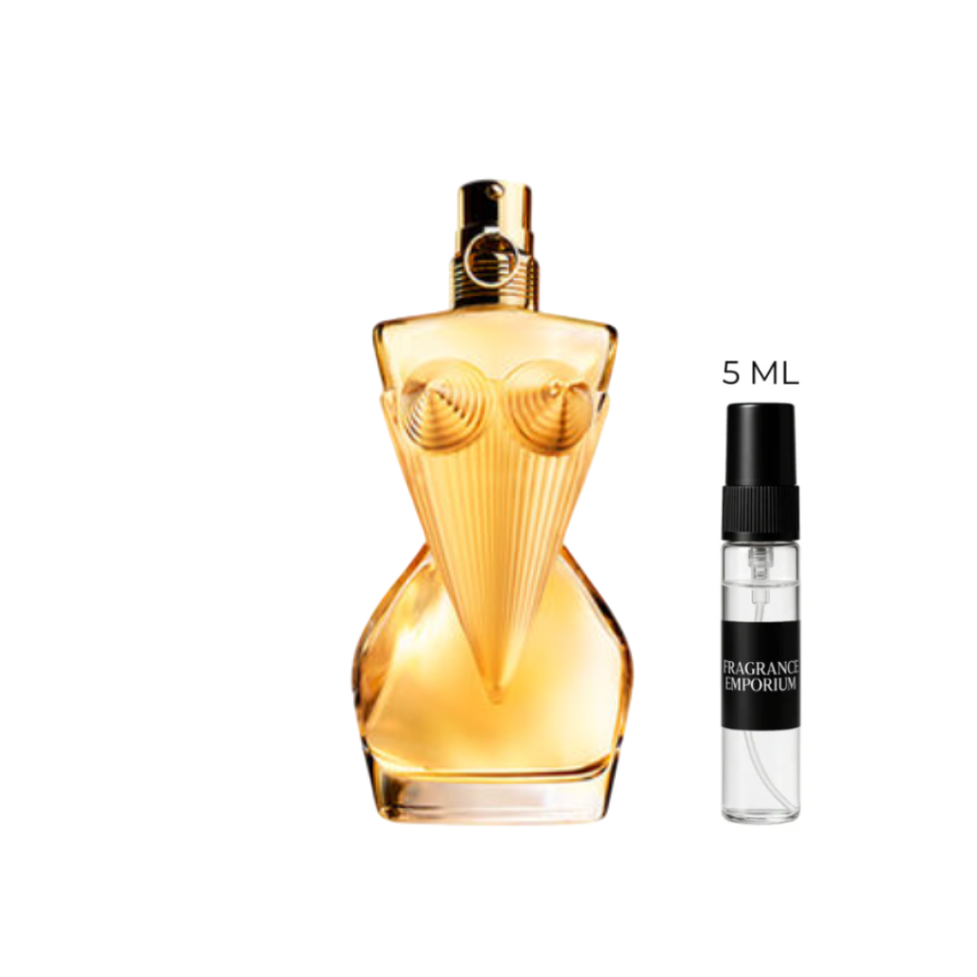 Jean Paul Gaultier Divine Eau de Parfum bottle next to a 5 ml sample vial under soft studio lighting. A radiant blend of lily, ylang-ylang and musk that embodies modern femininity — offered in 5 ml premium samples by Fragrance Emporium.