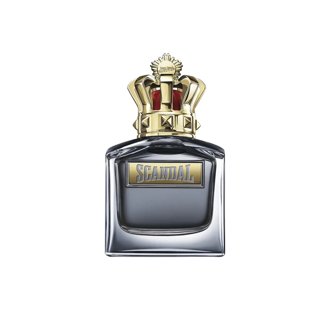 Close-up of Jean Paul Gaultier Scandal Pour Homme Eau de Toilette 100 ml featuring its refined silver bottle topped with a golden crown cap. The image captures the fragrance’s royal-inspired design and seductive woody amber character, blending notes of mandarin orange, caramel, tonka bean, and vetiver for a bold masculine scent.