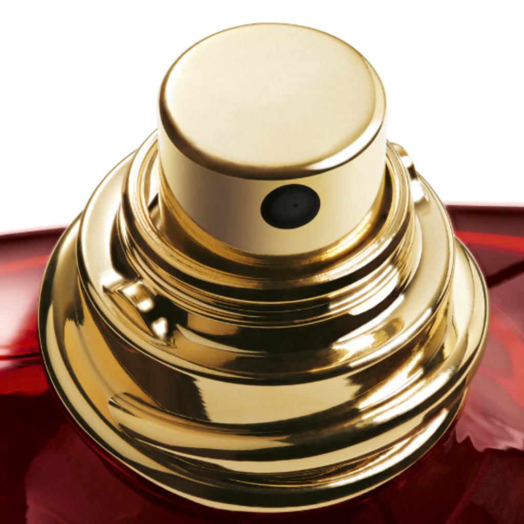 Detailed macro shot of the luxurious gold cap of Emporio Armani Stronger With You Tobacco Eau de Parfum. The close-up emphasizes the fragrance’s sophisticated design and the golden tones that mirror its warm blend of tobacco, spices, and bourbon vanilla accords.