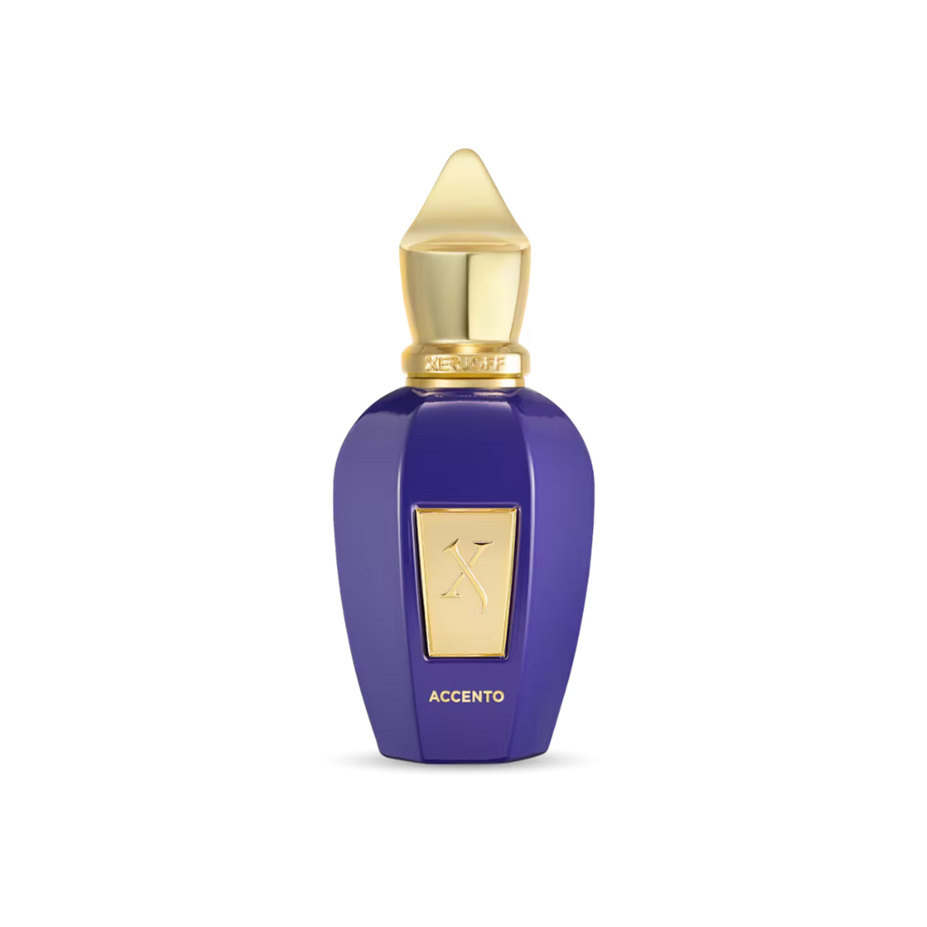 Luxurious close-up of Xerjoff Accento Eau de Parfum 100 ml in its royal purple bottle with a golden cap. The image highlights the fragrance’s refined fruity-floral composition with pineapple, hyacinth, and jasmine, evoking elegance, radiance, and timeless sophistication.