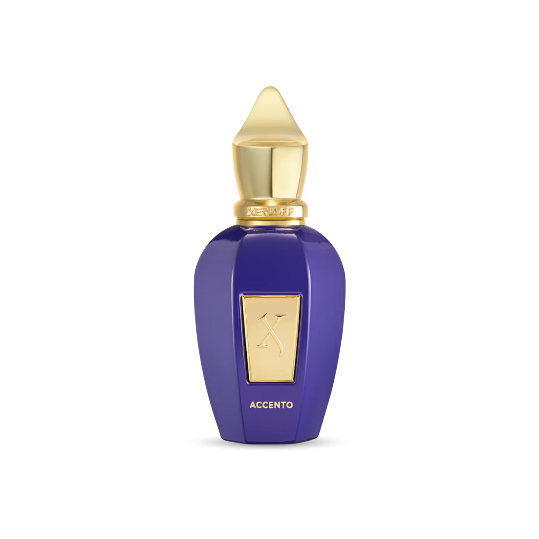 Luxurious close-up of Xerjoff Accento Eau de Parfum 100 ml in its royal purple bottle with a golden cap. The image highlights the fragrance’s refined fruity-floral composition with pineapple, hyacinth, and jasmine, evoking elegance, radiance, and timeless sophistication.