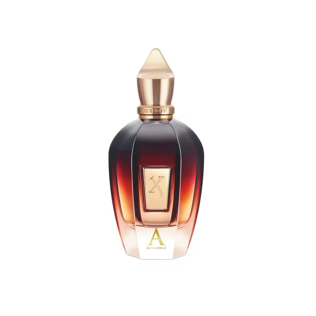 Elegant close-up of Xerjoff Alexandria II Eau de Parfum 100 ml in its signature amber-red bottle with golden cap and plate. The image captures the opulent design and the fragrance’s rich oriental-woody profile, blending notes of lavender, apple, rosewood, oud, amber, and vanilla for a luxurious unisex scent inspired by Arabian perfumery.